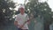 Portrait of tennis player boy holding tennis racket on court outdoors, professional sports