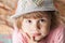 Portrait of thinking cute Caucasian blond baby girl