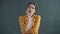 Portrait of thoughtful lady looking at camera touching chin standing on gray background thinking over problem