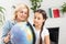 Portrait of thoughtful mother and daughter sitting at table with globe