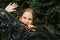 Portrait thoughtful serious candid eight year old kid girl face peeking out of abstract metal shapes in nature. prepubertal age of