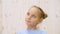 Portrait thoughtful teenager girl on a light background in studio. Close up stubborn face thinking girl looking up