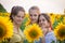 Portrait of three adorable girls on sunflower field