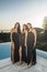 Portrait of three beautiful females in a party wearing different long black dresses