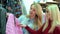 Portrait of three beautiful young women shopping in a clothes shop.