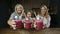 Joyful family drinking fresh berry smoothie
