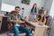 Portrait of three happy positive employees sitting chair develop project startup indoors