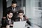 Portrait of three indian coworkers discussing business plan in office