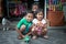 Portrait of three Indonesian siblings posing for a photograph.