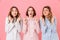 Portrait of three pleased young girls 20s wearing colorful strip