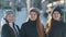 Portrait of three teenage girls posing, hugging and smiling in winter outside