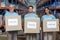 Portrait of three volunteers holding a donations box