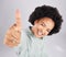 Portrait, thumbs up and black woman top view in studio isolated on a white background. Success, happiness and person