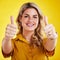 Portrait, thumbs up and motivation with a woman on a yellow background in studio to say thank you. Face, hands and