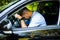 Portrait of tired businessman driving a car