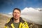 Portrait of a tired serious man in the mountains. Tourist climber on the background of Mount Kazbek