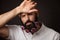 Portrait of tired unshaven man with beard and moustache with chrysanthemum flowers