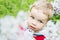 Portrait Toddler boy plucks flowers