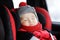 Portrait of toddler boy sleeping in car seat