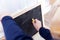 A portrait of a toddler drawing, scribbling or doodling a bit on a chalkboard. The child is writing on the blackboard and has a