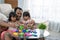 Portrait of togetherness father and his two daughters playing colorful alphabet text