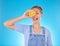 Portrait, tongue out and woman with orange in studio isolated on a blue background. Face, fruit and person with food for