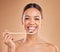 Portrait, toothpaste or woman brushing teeth with product for healthy oral or dental hygiene in studio. Face, smile