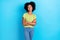 Portrait of toothy beaming satisfied girl wavy hairstyle wear green t-shirt standing hands crossed isolated on blue