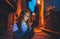 Portrait tourist girl using mobilephone with eyeglasses reflection of screen light backdrop of street old historical city at night