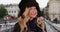 Portrait of tourist woman in cozy hat and scarf in Paris, France