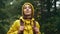 portrait tourist woman in yellow jacket at forest, standing looking around, inspiring, fall weather, calm scene