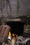 Portrait of a traditional stove and pot used to recycle household waste on a smoldering fire.