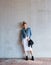 Portrait, travel and smile with a woman on a concrete wall as a tourist leaning against a building in the city. Fashion