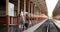 Portrait traveler assian woman walking and waits train on railway platform.