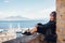 Portrait of traveler girl enjoying Vesuvius and the gulf of Napoli view from the Castel dell`Ovo wall