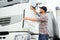 Portrait of trucker standing by his truck ready for driving. Driver occupation. Transportation services