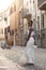 Portrait of turist woman dressed in white getting to know Europe, Ferrara. Italy
