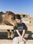 Portrait of twelve year old girl with a dromedary that is giving her love