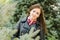 Portrait a twenty-five girls on the background of fir trees