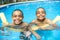 Portrait of twin brother boy having good time in swimming pool