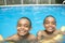 Portrait of twin brother boy having good time in swimming pool