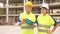 Portrait of two active positive civil engineers on the construction site.