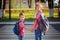 Portrait two adorable boys with backpack near pedestrian crossin