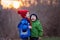 Portrait of two adorable boys, brothers, on a winter day, sunset