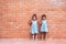 Portrait of two asian kid girls pointing up