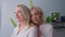 portrait of two attractive blonde Caucasian women medium closeup indoor well-being concept