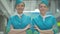 Portrait of two beautiful Caucasian women in stewardess uniform with hands crossed looking at camera and smiling