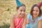 Portrait of two beautiful girls in a holiday hat. Holiday in nature.