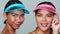 Portrait of two beautiful happy Asian women in sun visor cap smiling looking at the camera over white