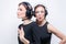 Portrait of two beautiful women with headsets. Technical support concept